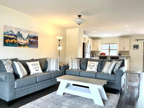 a living room with a couch and a coffee table at Perfect base Invermere 3bd townhouse mt views with garage in Invermere