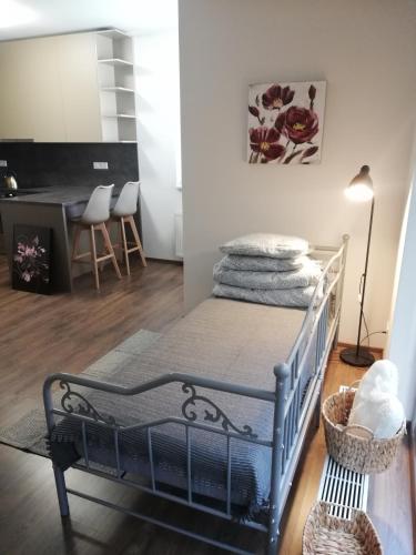 a bedroom with a bed with a table and a desk at GLAM apartmán Bučovice in Bučovice