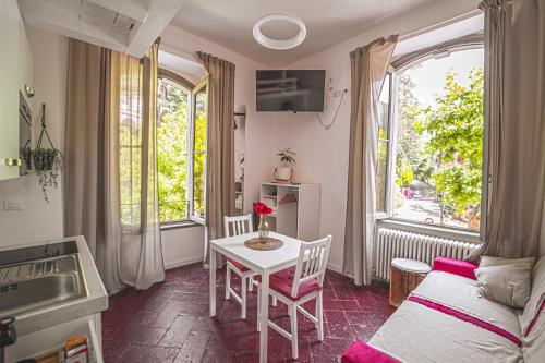 a living room with a table and a couch at AvocadoHouse2VistaTerme in San Pellegrino Terme