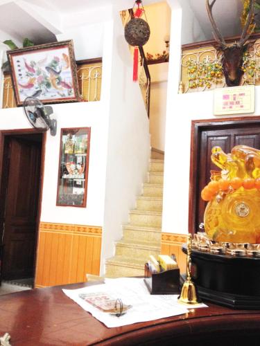 a room with a staircase and a desk with a table sidx sidx at North Hostel N.2 in Hanoi