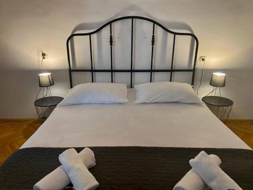 a bedroom with a large bed with two towels on it at Niky in Betina