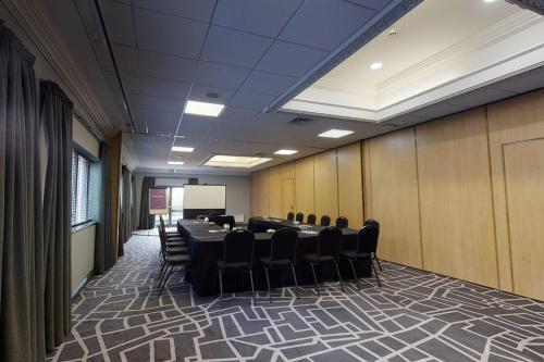 a conference room with a long table and chairs at Village Hotel Newcastle in Newcastle upon Tyne