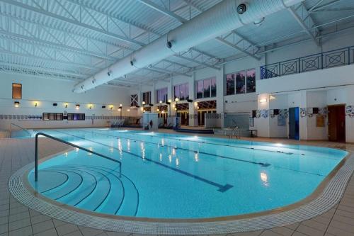 a large swimming pool in a large building at Village Hotel Newcastle in Newcastle upon Tyne