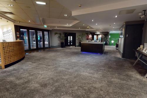 a large room with a desk in the middle at Village Hotel Newcastle in Newcastle upon Tyne