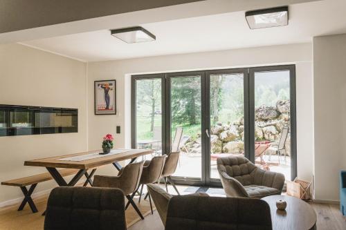 a living room with a table and chairs at MountainLodge am Ötscher in Lackenhof