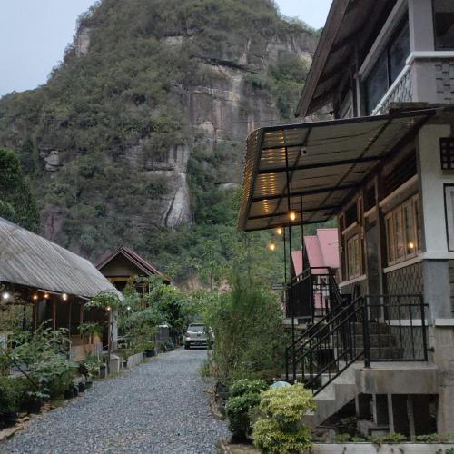 a house with a mountain in the background at Roemah Abdoe in Arau