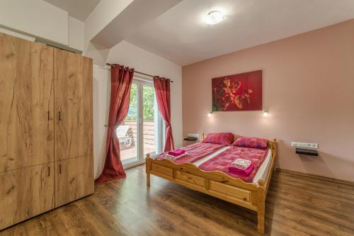 a bedroom with a bed and a large window at Mountain View Lodge Bulgaria in Ranentsi
