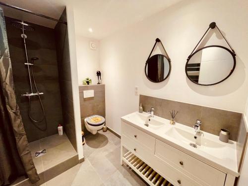 a bathroom with a sink and a shower and a toilet at La Villa Perroquet in Poncins