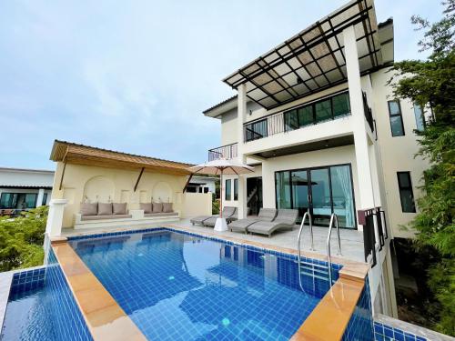 a house with a swimming pool in front of it at High Life Villas in Salad Beach