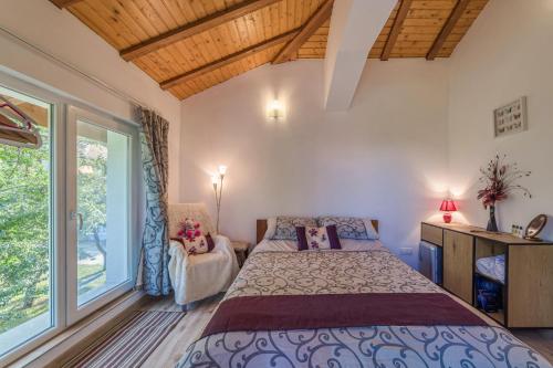 a bedroom with a bed and a large window at Mountain View Lodge in Ranintsi