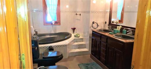 a bathroom with a tub and a toilet and a sink at Charming Villa La Mar in Albox