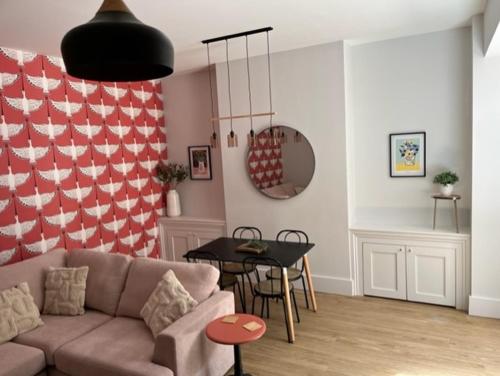 a living room with a couch and a table at Redwing- free parking- Grade II listed- ground floor two bedrooms apartment in Huntingdon