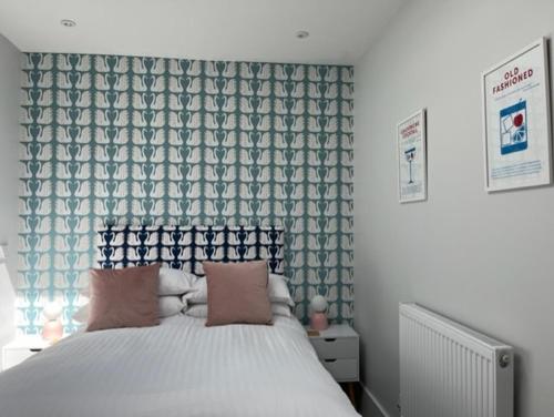 a bedroom with a large bed with a curtain at Redwing- free parking- Grade II listed- ground floor two bedrooms apartment in Huntingdon