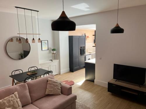 a living room with a couch and a table at Redwing- free parking- Grade II listed- ground floor two bedrooms apartment in Huntingdon