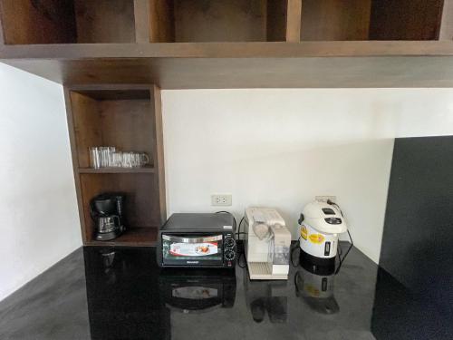 a kitchen with a coffee maker and a toaster at High Life Villas in Salad Beach