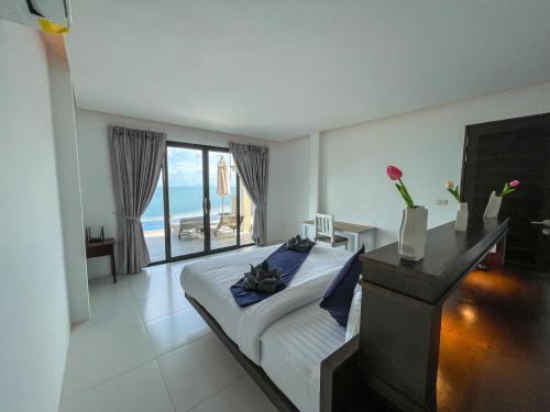 a bedroom with a bed with a view of the ocean at High Life Villas in Salad Beach