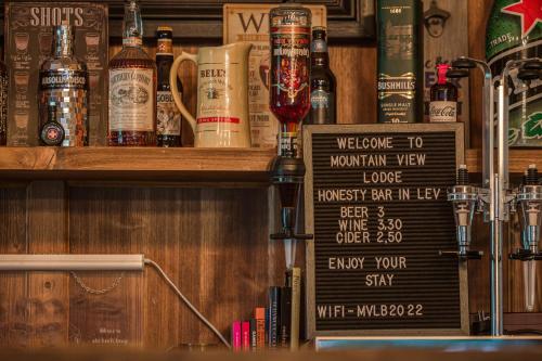a bar with a lot of bottles of alcohol at Mountain View Lodge Bulgaria in Ranentsi