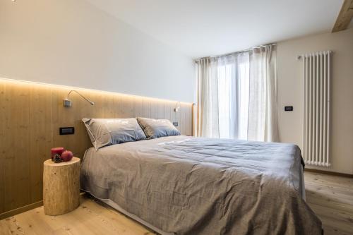 a bedroom with a large bed and a window at Folgaria Top Rent in Folgaria