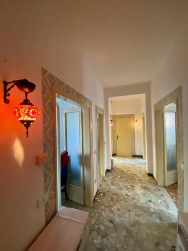 a room with a hallway with doors and a chandelier at Venice -Mestre Rooms in Mestre