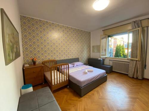 a bedroom with a bed and a chair and a window at Venice -Mestre Rooms in Mestre
