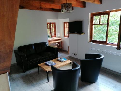 a living room with a couch and a table at Chalet Le Tyrolien, au coeur du Boréon in Saint-Martin-Vésubie