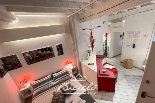 フェラーラにあるBiciclo' Rosso Ferraraのベッドとデスクが備わる客室です。