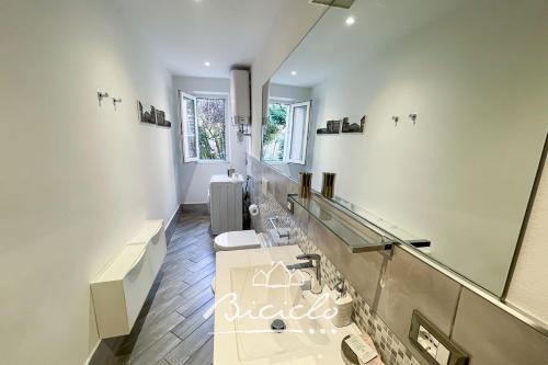 a bathroom with a sink and a mirror at Biciclo' Rosso Ferrara in Ferrara