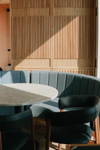 a conference room with a table and blue chairs at Aethos Ericeira in Ericeira