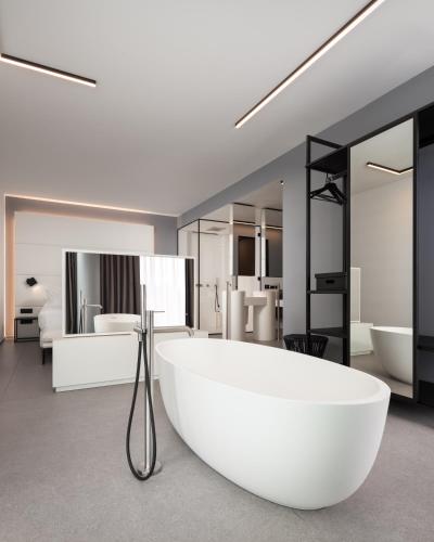 a bathroom with a large white bath tub in the middle at J44 Lifestyle Hotel in Lido di Jesolo