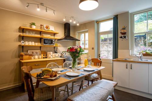 a kitchen with a wooden table with a bowl of food on it at Cosy cottage in the heart of Bakewell in Bakewell