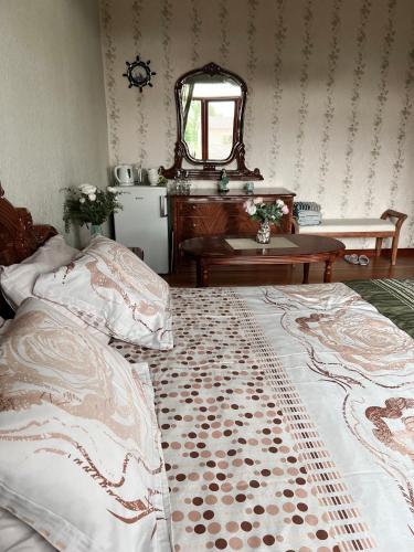 a bedroom with two beds and a mirror and a table at Villa Avoti in Sigulda