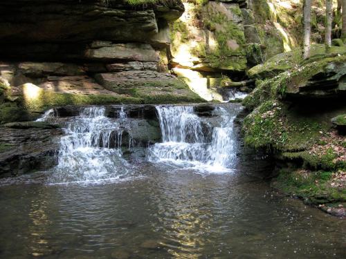 a waterfall in a pool of water next to a rock wall at Ferienhaus Fuchseck in Bad Liebenzell