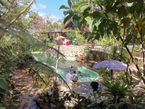 a group of people in a pool at a water park at Finca de la Vaca - Glamping in Palora