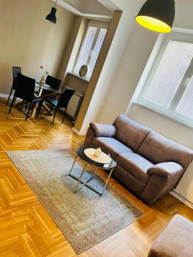 a living room with a couch and a table at Apartman Lulu 2 in Sarajevo