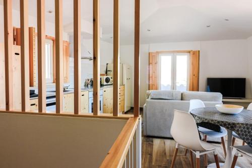 a kitchen and living room with a table and chairs at Refúgio da Fortaleza in Sesimbra