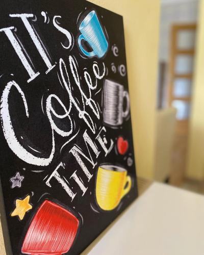 a chalkboard with the words it is a coffee cup at Apartment Zabljak Center in Žabljak