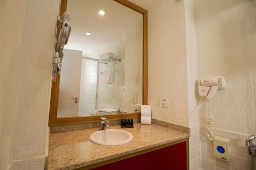 a bathroom with a sink and a mirror at Lobie Queen Ipanema in Rio de Janeiro