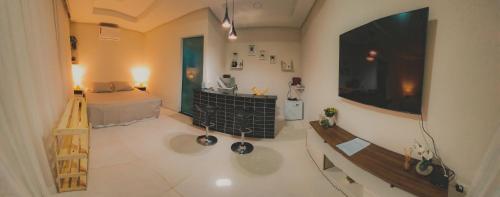 a large room with a bed and a large television at Flat Noronha Dreams in Fernando de Noronha