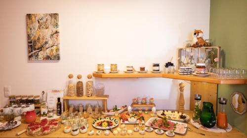a table with plates of food on top of it at Aparthotel Chiemgaufuchs - CHIEMGAUKARTE in Inzell