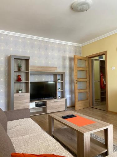a living room with a television and a table at Apartment Zabljak Center in Žabljak