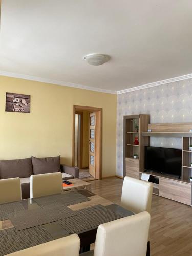 a living room with a couch and a table at Apartment Zabljak Center in Žabljak