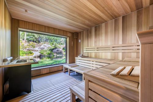 a sauna with wooden walls and a large window at Vista Resort & Club in Prague
