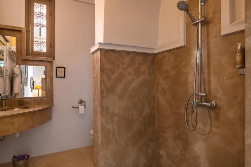 a bathroom with a shower and a sink at Riad Altair in Marrakech