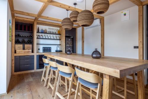 a kitchen with a large wooden table and chairs at Vista Resort & Club in Prague