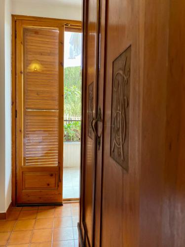 an open door to a room with a wooden at Casa Uliveto in Mattinata