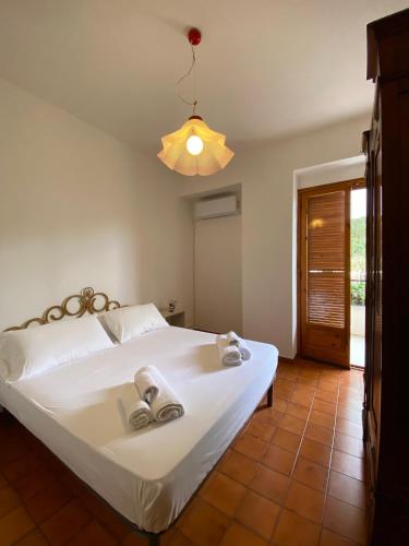 a bedroom with a white bed with towels on it at Casa Uliveto in Mattinata
