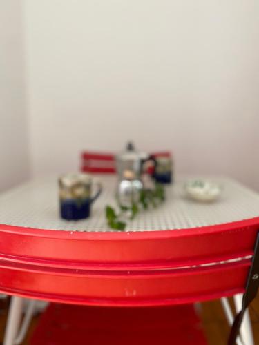 a red chair with a table with food on it at Casa Uliveto in Mattinata
