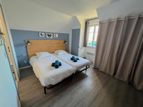 a bedroom with a bed with two shoes on it at Ma maison à Disneyland Paris in Magny-le-Hongre