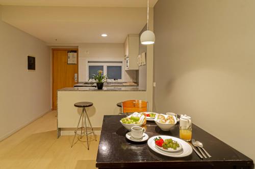 a kitchen with a table with two plates of food on it at Lobie Queen Ipanema in Rio de Janeiro