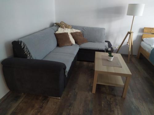 a living room with a couch and a coffee table at PISQOR Apartment - self check-in in Bratislava